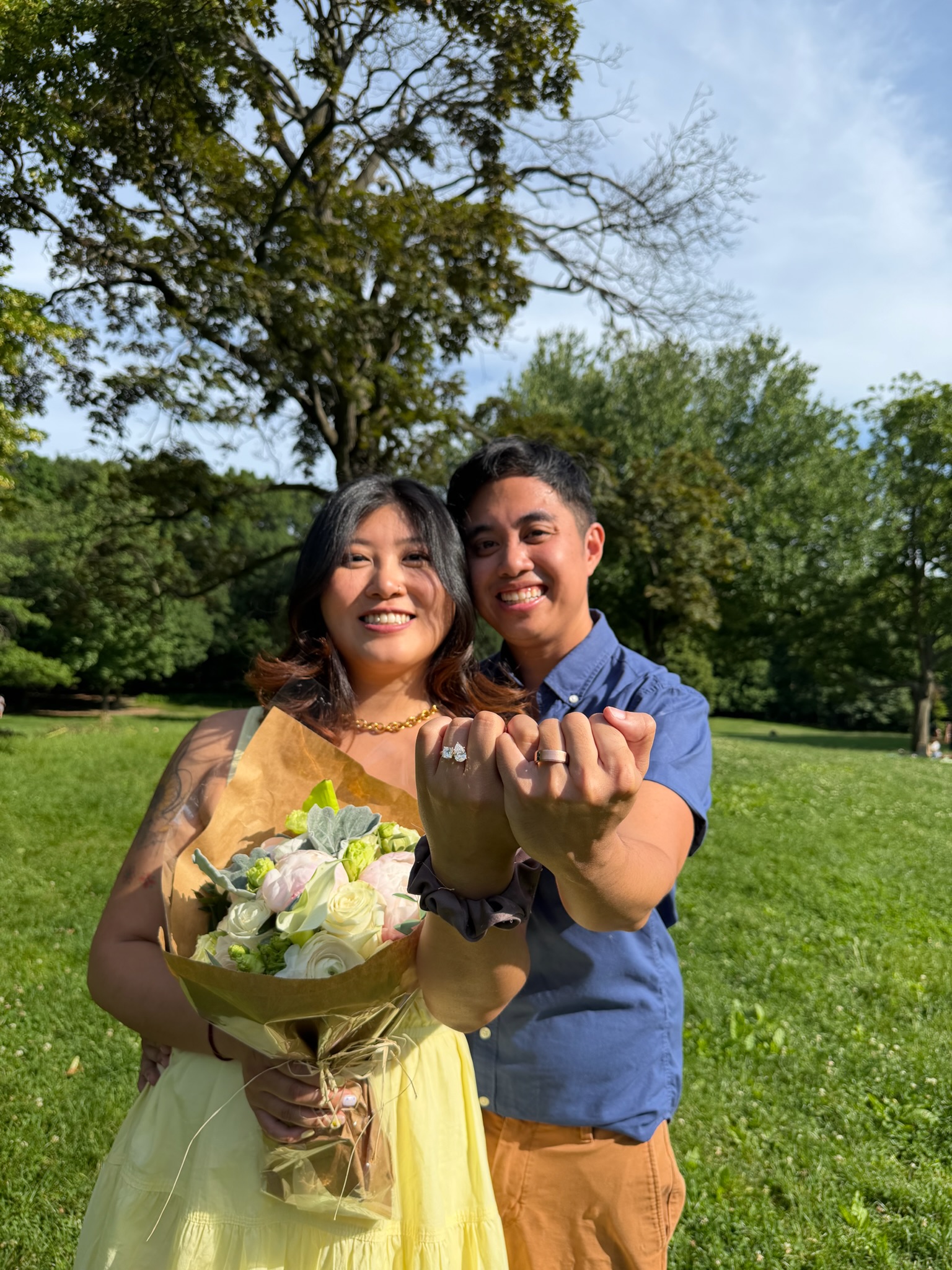 Daye and Yorick showing their custom toi et moi engagement rings after a mutual proposal, designed at Haejin Jewelry Brooklyn