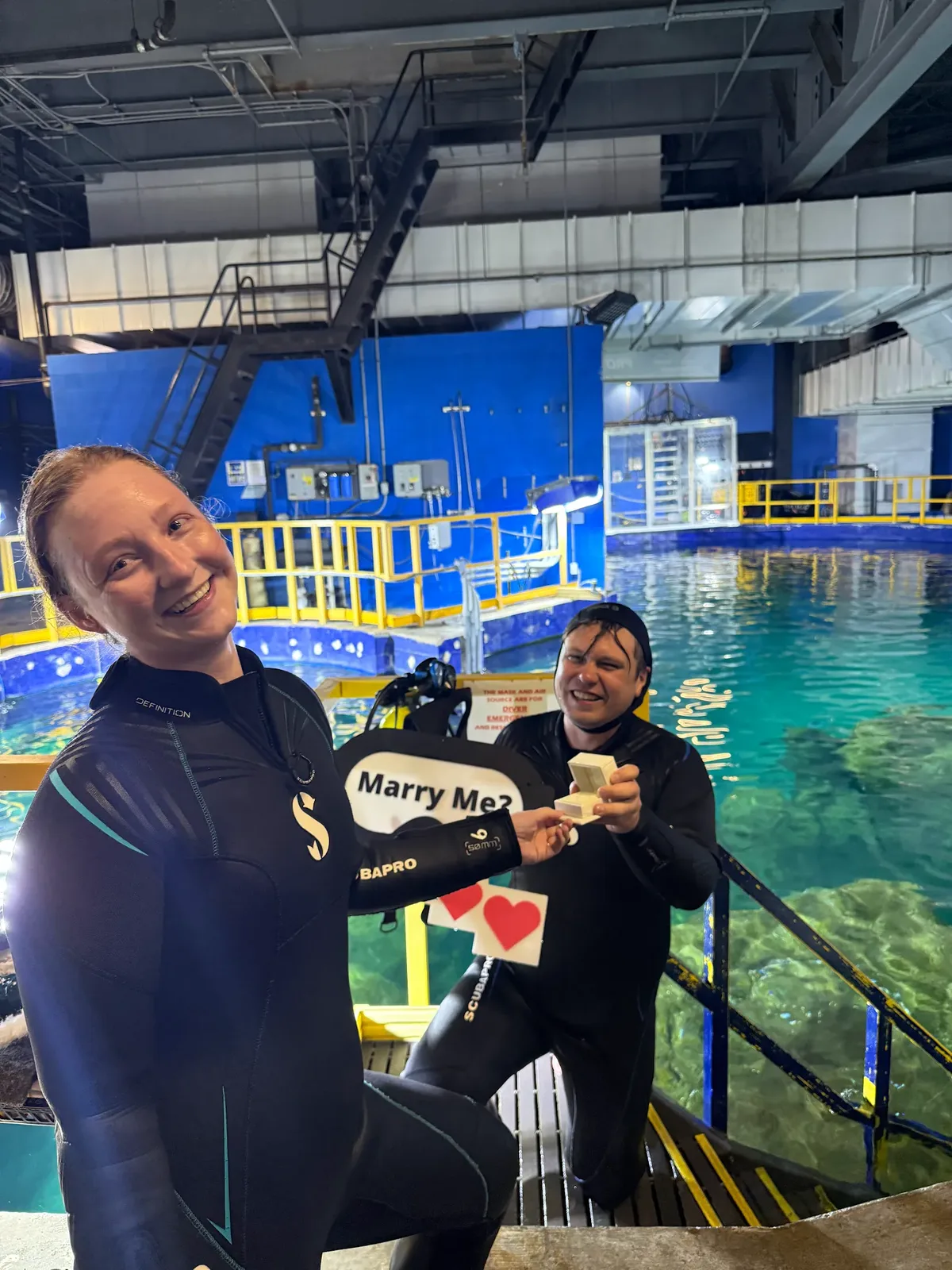 Happy couple after underwater scuba proposal with Haejin Jewelry engagement ring box