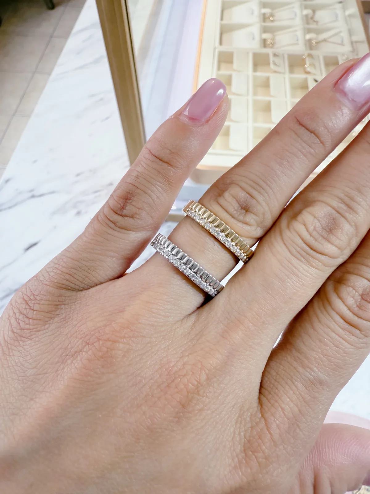 Three stacked wedding bands with baguette and round diamonds in white and yellow gold, mixed metal stack, Haejin Jewelry Brooklyn