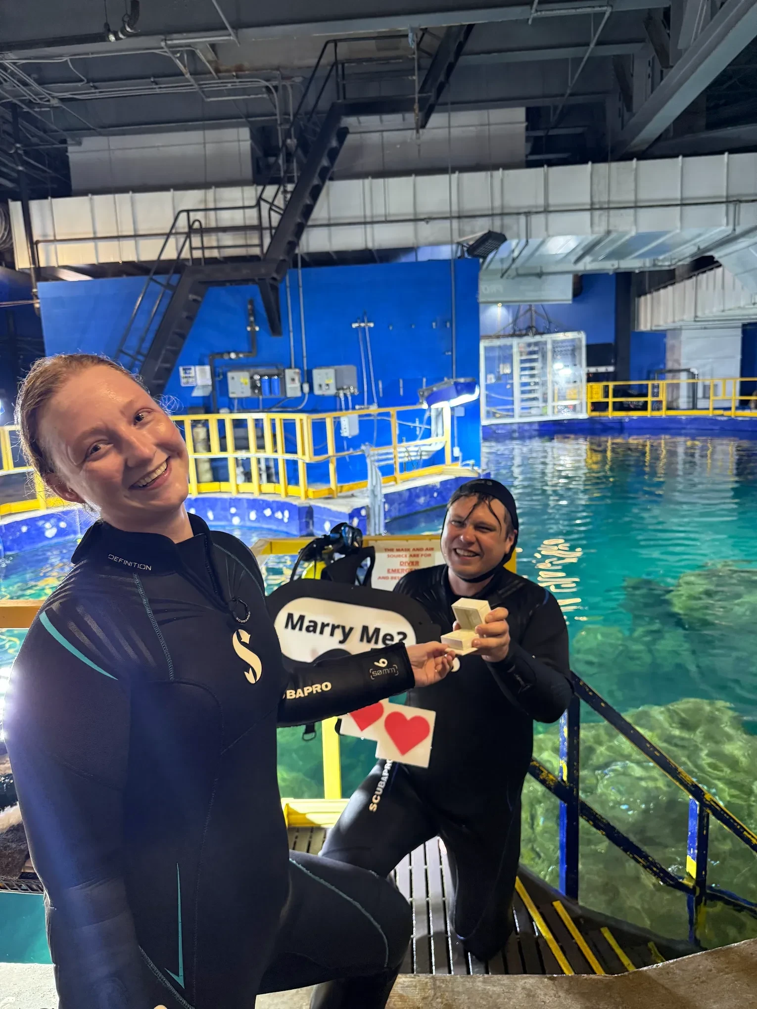 Happy couple after underwater proposal showing Haejin custom engagement ring