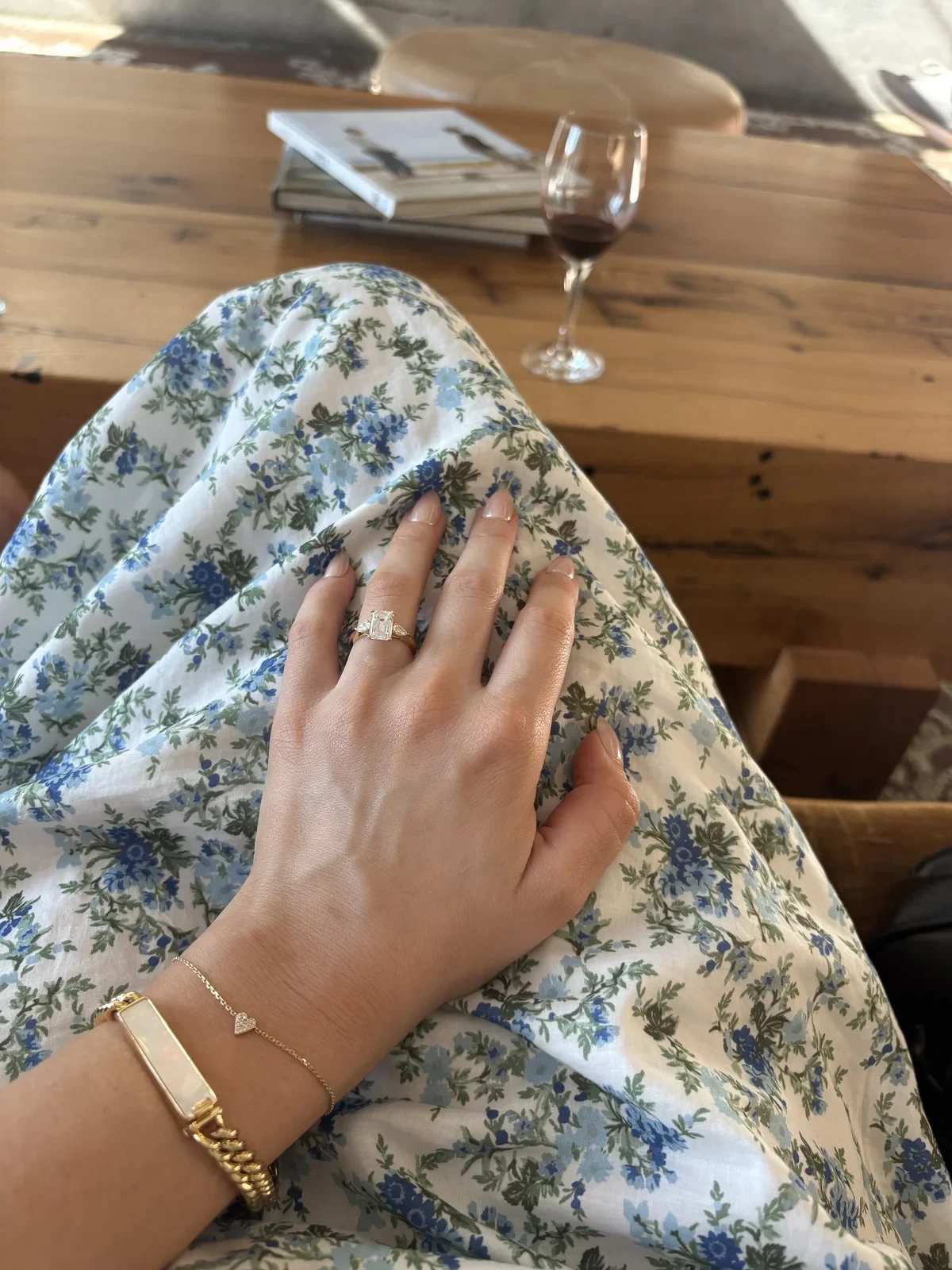 Custom emerald cut three-stone engagement ring in yellow gold on hand, designed at Haejin Jewelry Brooklyn