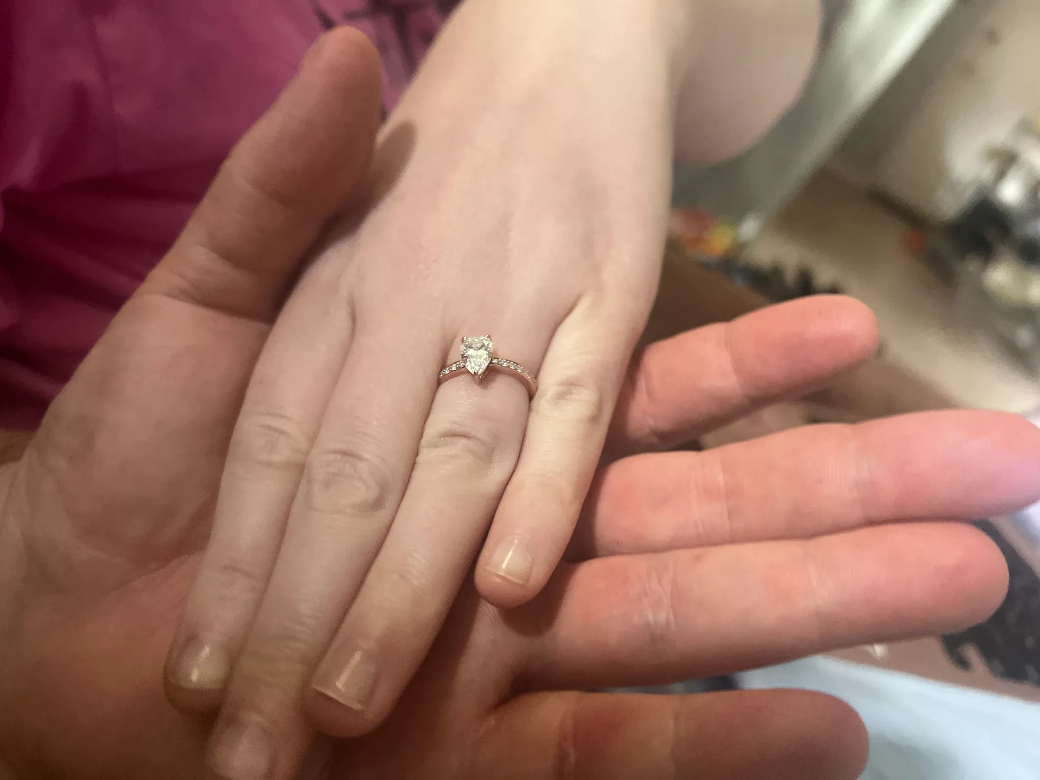 Pear shaped lab grown diamond engagement ring on hand with pave band, custom designed at Haejin Jewelry Brooklyn