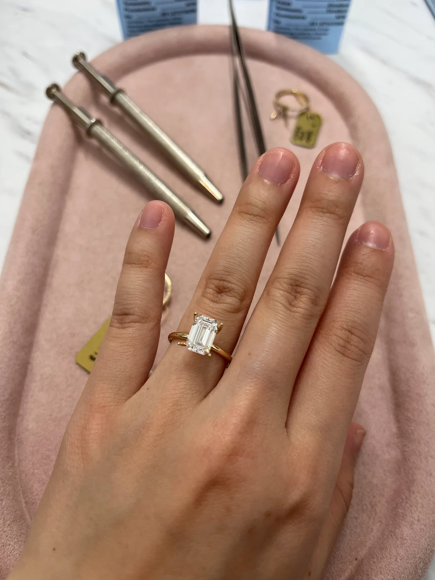 Emerald cut lab-grown diamond solitaire engagement ring tried on at Haejin Jewelry Brooklyn