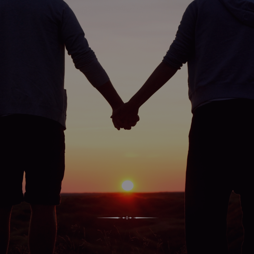Couple holding hands at sunset symbolizing love and lifelong promise