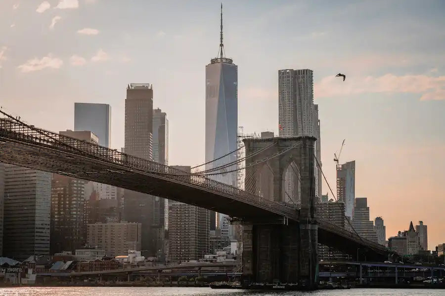 Williamsburg Bridge at sunset in Brooklyn NYC, symbolizing the journey couples and visitors take when shopping for custom engagement rings with Haejin Jewelry.