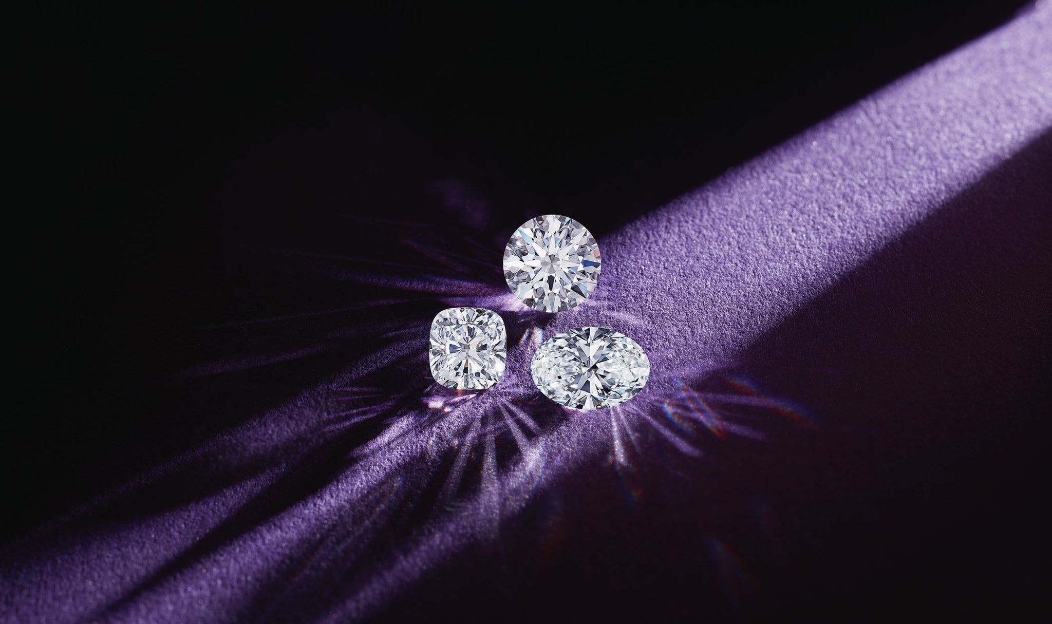 Loose lab-grown diamonds under spotlight representing IGI and GIA certification standards