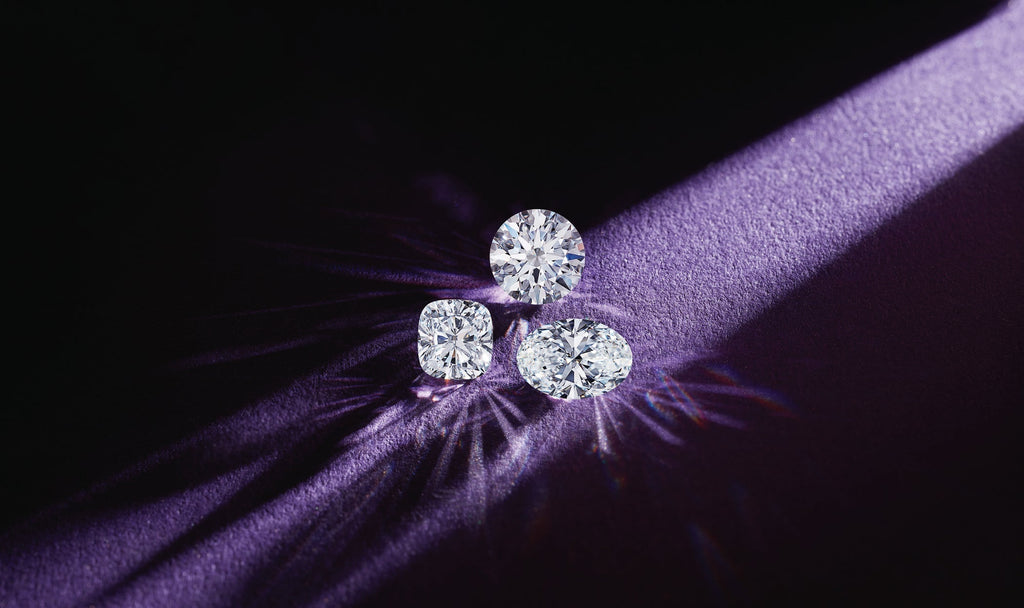 Loose lab-grown diamonds under spotlight representing IGI and GIA certification standards